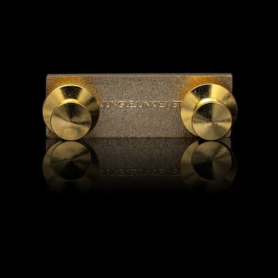 Back View of Small Rectangular Gold Metal Pin with two Circular Gold Fasteners. Text on back of pin reads, jungle junkie dot net.